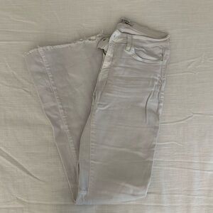 White flare jeans with fringe bottoms